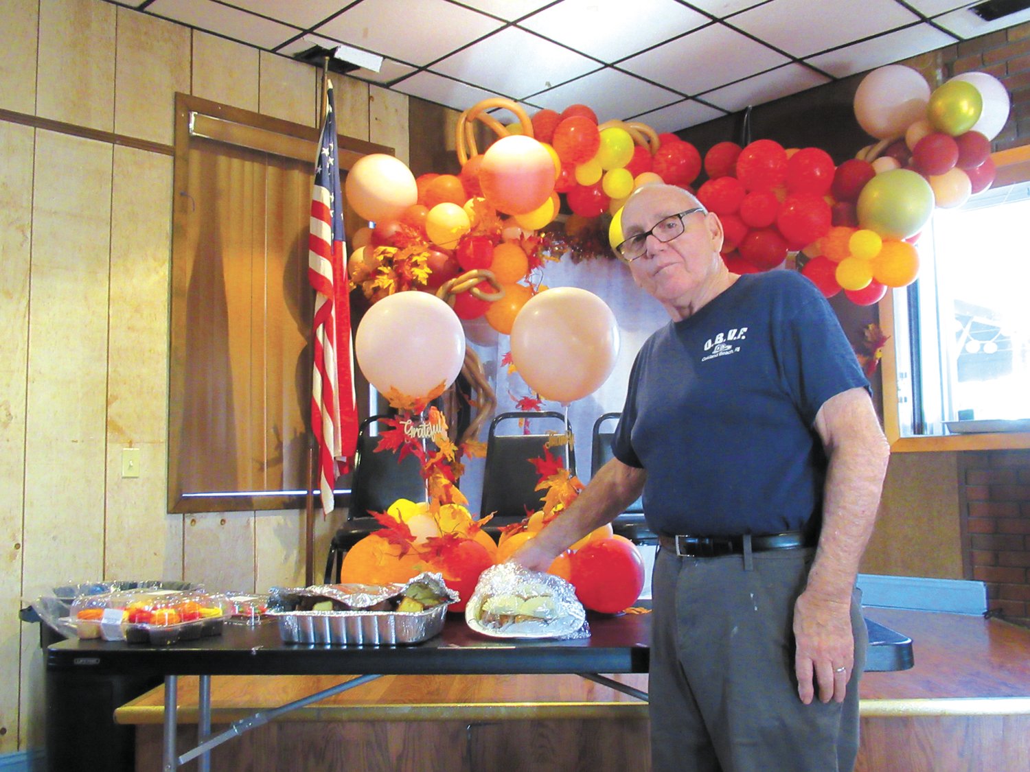 CALORIC CREATIONS: Ron Manfredo, long-time president of the Oakland Beach Firemen’s Club uncovers one of the many homemade dessert trays people enjoyed after their delicious turkey with all the fixings dinner.